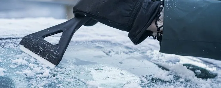 an ice scraper on a frosted windscreen — article card